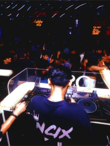 A view from behind the console, showing a packed dance floor. My focus is always on reading the room and playing the right tracks to keep the party going.