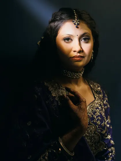 An artistic, moody shot of the sangeet look, playing with light and shadow.