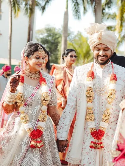 Hand in hand, the couple walks together, surrounded by their family. A perfect picture of unity.