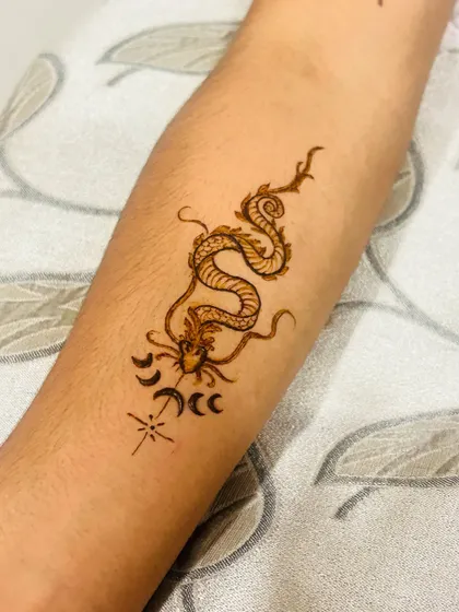 Mehendi isn't just for traditional patterns. I also create modern henna tattoos like this detailed dragon design on the forearm. It's a great way to have a temporary tattoo for a party or just for fun.