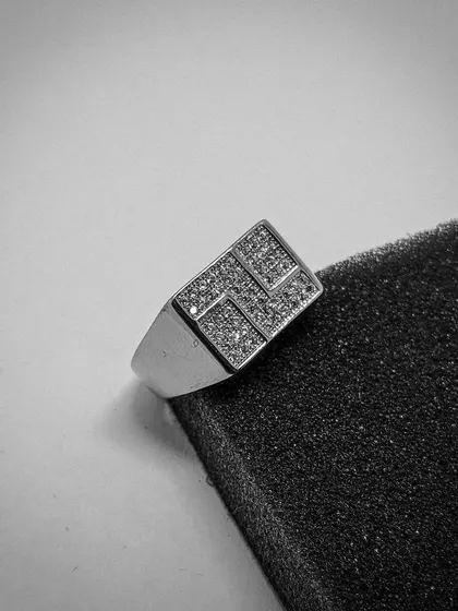 A modern take on the classic men's ring. This sterling silver signet ring features a bold, rectangular face with a geometric pattern paved with high-grade CZ stones, offering a sharp and contemporary look.