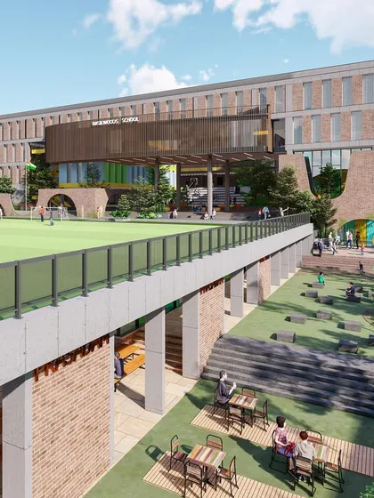 This view shows the relationship between the football ground on the upper level and the social "food street" below at Basil School. This innovative use of a sloping site maximizes usable space for students.