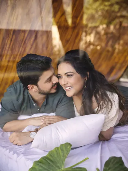 Laughter and love in a rustic cabin setting. This candid photo captures the couple's genuine connection. The styling was kept simple and natural to match the cozy, outdoor vibe of their pre-wedding shoot.