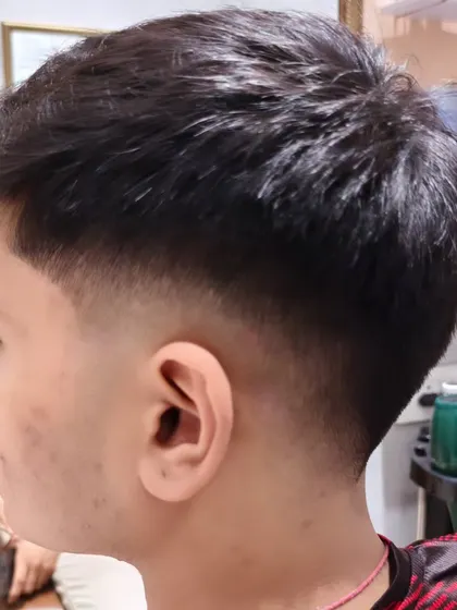 A fresh cut for this young gentleman, showing the before and after of his hair transformation.