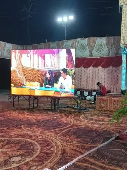 A large outdoor LED screen setup for a corporate event. These screens are perfect for live feeds, presentations, or video playback in any environment, day or night.
