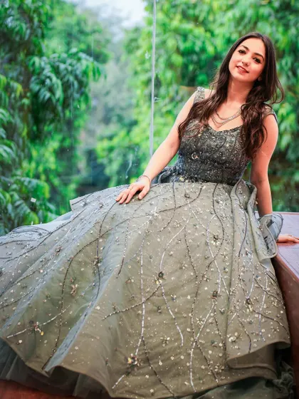 Feeling like a princess in this stunning grey ball gown from Laljees. The intricate silver work and voluminous skirt make it a perfect choice for a reception or cocktail party.