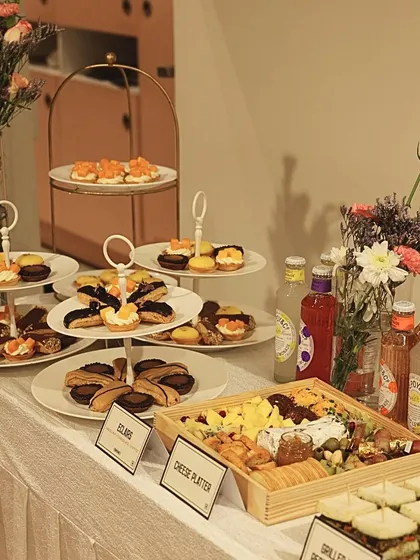 A beautifully arranged catering spread is art you can taste. For this event, I curated a selection of my finest offerings, including a custom cheese platter with artisanal crackers, delicate eclairs, mini fruit tarts, and refreshing beverages, all designed to impress guests at first sight.