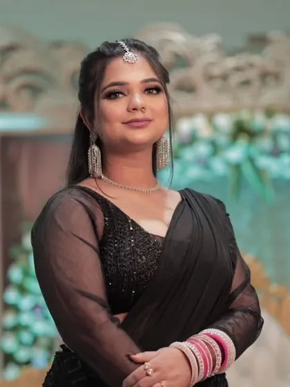A happy and confident reception portrait. The soft glam makeup with a hint of shimmer on the eyes perfectly suits the celebratory mood.
