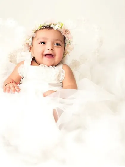 The pure joy on this baby's face says it all. The angelic theme is perfect for highlighting their innocent and happy spirit.