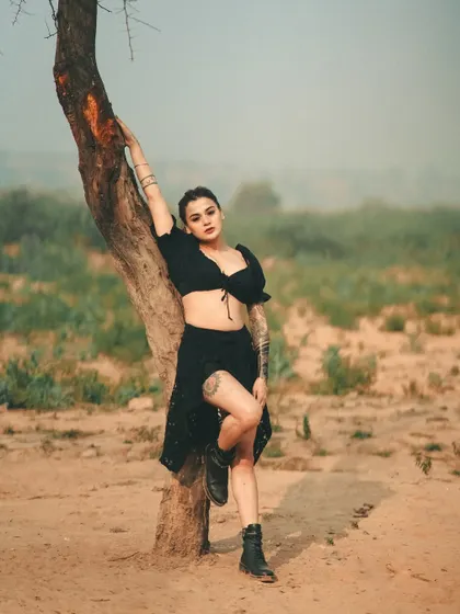 An outlaw in the wilderness. The desolate landscape, the edgy all-black outfit, and the strong pose come together to create a story of defiance and strength.