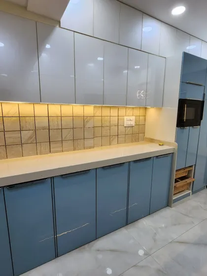 A full view of one side of the parallel kitchen, showing the seamless cabinetry and integrated appliances.