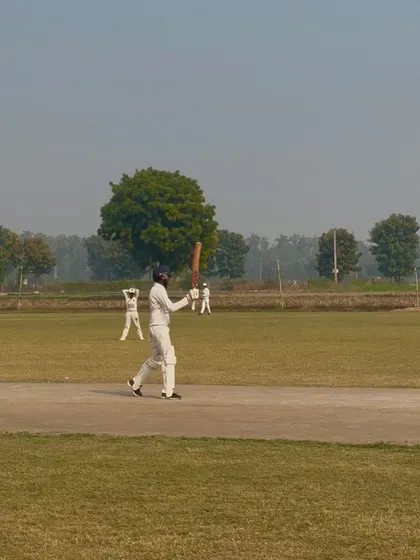 Abhigyan raises his bat to celebrate his fifty.