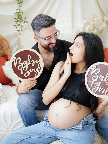 "Baby Boy or Baby Girl?" This fun gender reveal photo captures the couple's playful surprise and excitement.