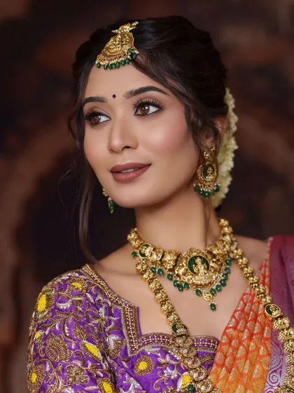 A close-up of our green-beaded temple jewellery set. The Goddess Lakshmi motif is central to this design, making it an auspicious choice for a wedding ceremony.