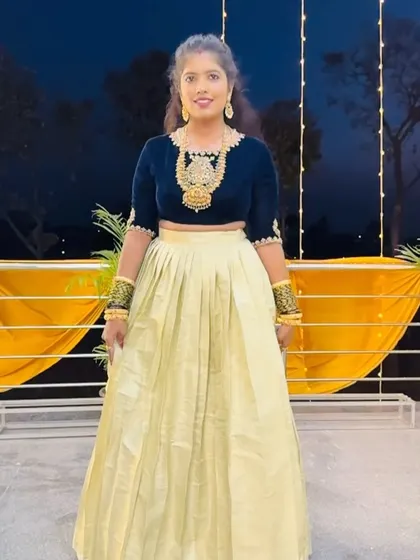 The client posing confidently, her custom crop top and skirt combination is a perfect example of modern ethnic fusion wear.