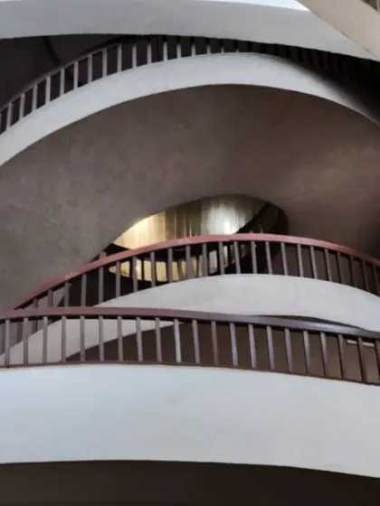The grand spiral staircase at the Nehru Centre. Its monumental scale and form create a powerful sense of movement and spatial choreography, guiding visitors through the building's multiple levels.