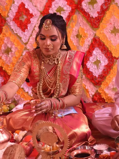 The bride during her wedding ceremony, comfortable and radiant in her perfectly draped saree.