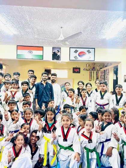 A happy and energetic group photo with students and parents celebrating the achievements of the day.