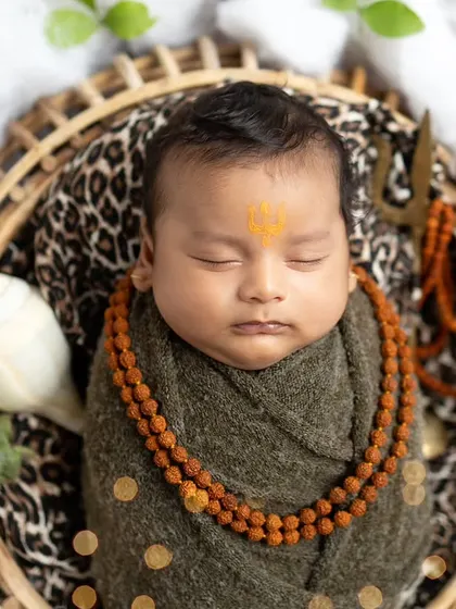 A close-up portrait of our little Mahadev, highlighting the peaceful expression and the tripundra on his forehead.