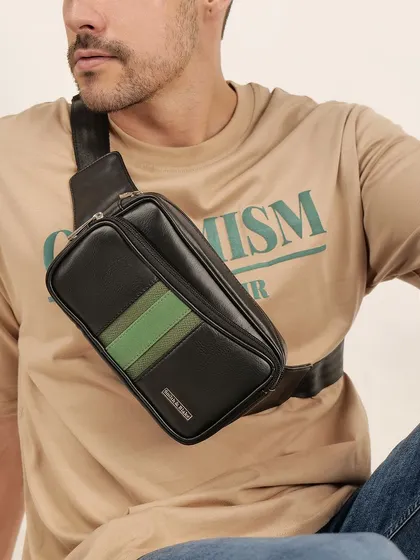 A close-up of a man wearing a black and green crossbody bag. This shows the product in use, highlighting its functionality and modern style.