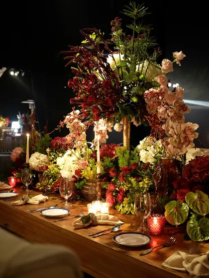 Another angle of the decadent floral runner, filled with a variety of blooms like roses, hydrangeas, and orchids in a rich color palette.