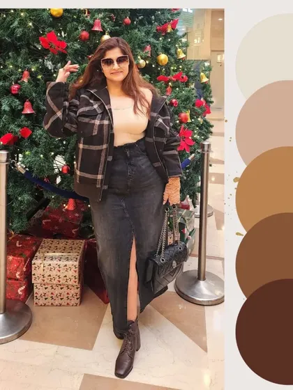 The full sustainable look with a brown plaid jacket, black denim skirt, and boots, set against a festive backdrop.