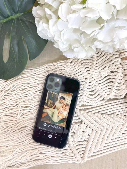 A custom glass phone cover featuring a Spotify song player design and a personal photo. It's a stylish and functional way to carry a memory with you, available for just ₹490.