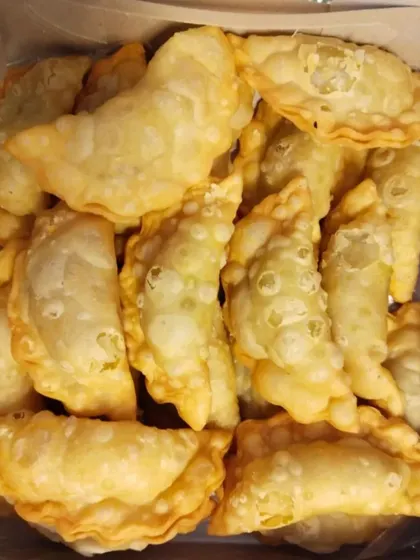 Halwa Puri, a traditional breakfast or snack item. The fluffy, deep-fried bread is served with a sweet semolina halwa, a classic combination.