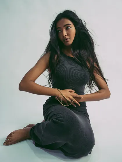 A seated pose that is both elegant and strong, showcasing the model's control and grace.