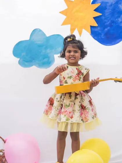 Another shot of the yellow floral dress, showing how it moves with her as she plays. It's a perfect blend of style and comfort.