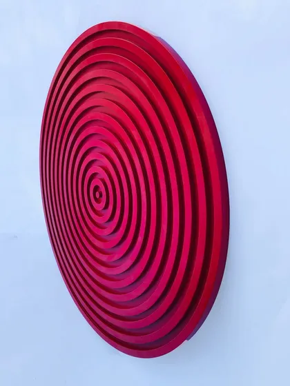 This side view shows the sculptural, bowl-like shape of the concentric circles piece. It is crafted from durable, water-resistant HDMR MDF.