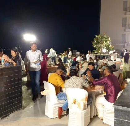Guests enjoying an outdoor dinner party at a private residence. Our team handles all aspects of catering for house parties, allowing you to be a guest at your own event.