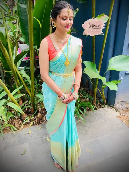 A lovely outdoor shot of the sister of the bride. The natural light shows off her fresh, dewy makeup look.