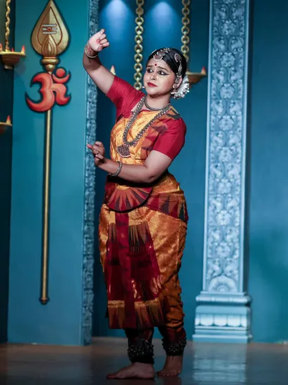 Performing under the symbol of 'Om' during the Natyanjali festival. This photo shows a pose dedicated to the divine, where the entire body is engaged in expressing a single idea. It reflects the spiritual foundation of my dance.