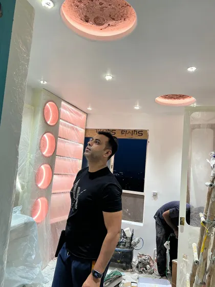 Checking the installation of custom moon-themed ceiling lights in a kid's room. The details make the design.