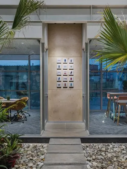 A perfect example of landscape and interiors merging. This meeting space opens directly onto a courtyard filled with pebbles and tropical plants, blurring the line between inside and out.