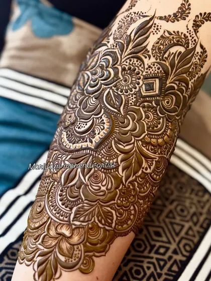 A close-up shot highlighting the fine details and shading in a bridal arm design.