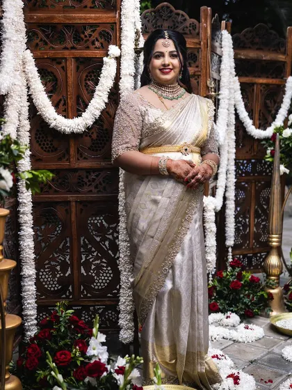 A full view of this elegant ensemble. The off-white saree and custom blouse create a look of timeless sophistication for the naming ceremony.