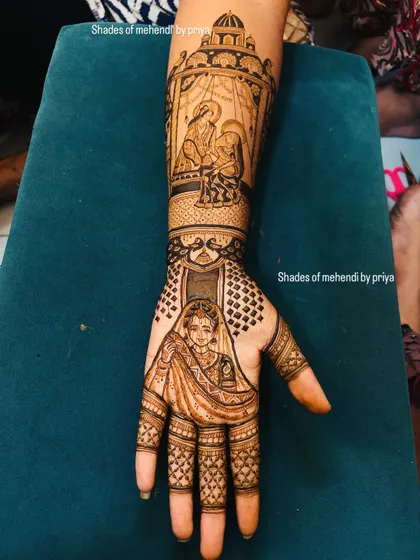 This bridal mehendi features a beautiful portrait of the bride on the palm, with a 'doli' (palanquin) scene on the forearm, symbolizing her journey.
