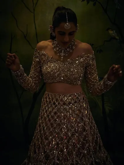 The drama of the 'Mela Rouge' look. This shot captures the mood and artistry of the gold Manish Malhotra lehenga, a perfect example of how we build a complete story around an outfit for a themed gala.