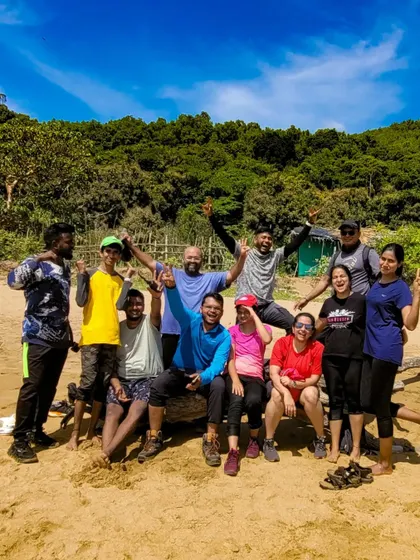 A happy and energetic group posing on a beach in Gokarna. The smiles say everything about the success of this coastal adventure.
