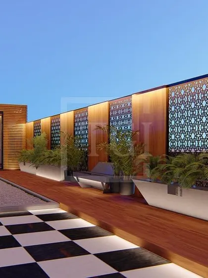 Another view of the Gurgaon project, showing a long pathway with planters and a feature wall combining wood and intricate jaali screens.