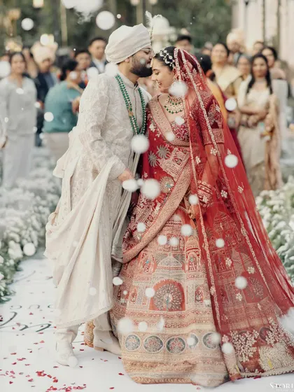 A quiet moment of affection amidst the ceremony. For me, capturing these unscripted gestures is just as important as the grand rituals. This is the timeless love story of Kunal and Parul.
