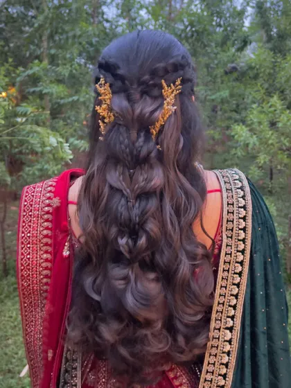 A stunning half-updo with intricate braids and golden leaf accessories, a truly magical look.