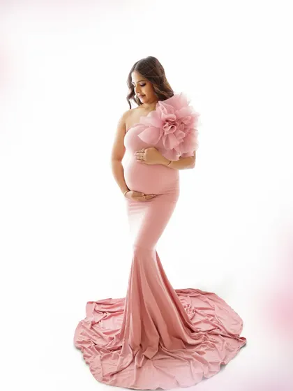 A duplicate of image 152, this stylish portrait in a form-fitting pink gown with a large floral detail is modern and artistic.