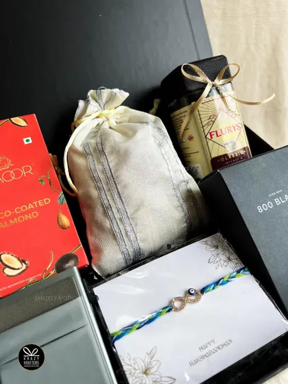 The 'Rakhi Reserve' hamper for him, featuring premium coffee, choco-coated almonds, a card holder, and an infinity evil eye rakhi.