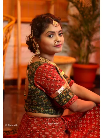A seated portrait in a warm, inviting indoor setting, perfect for capturing the essence of traditional style.