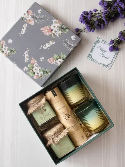 This elegant grey floral box is filled with jars of our chocolate clusters and other gourmet snacks, paired with two beautiful ombre glasses. It's a gift that speaks of sophistication.