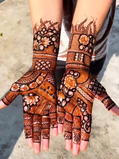 A beautiful example of a 'bel' or vine-style design on the palms, filled with flowers and leaves. The use of bold outlines and delicate shading gives it a lovely texture.
