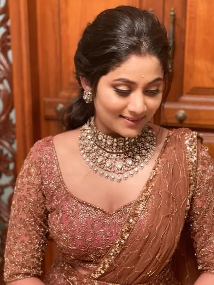 A close-up of a client's reception makeup. The soft brown tones and the detailed choker create a warm and elegant look.